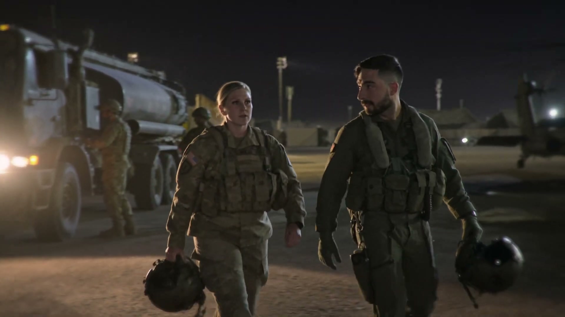 Pilots Hollis and Nazari walk the flight line at night.